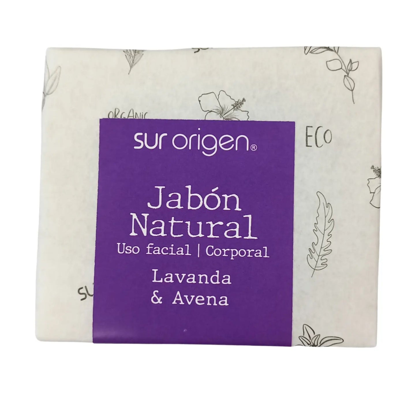 Barra de jabón natural Sur Origen envuelta en papel decorado con ilustraciones botánicas. Fórmula de lavanda y avena para uso facial y corporal. Etiqueta morada con detalles ecológicos.