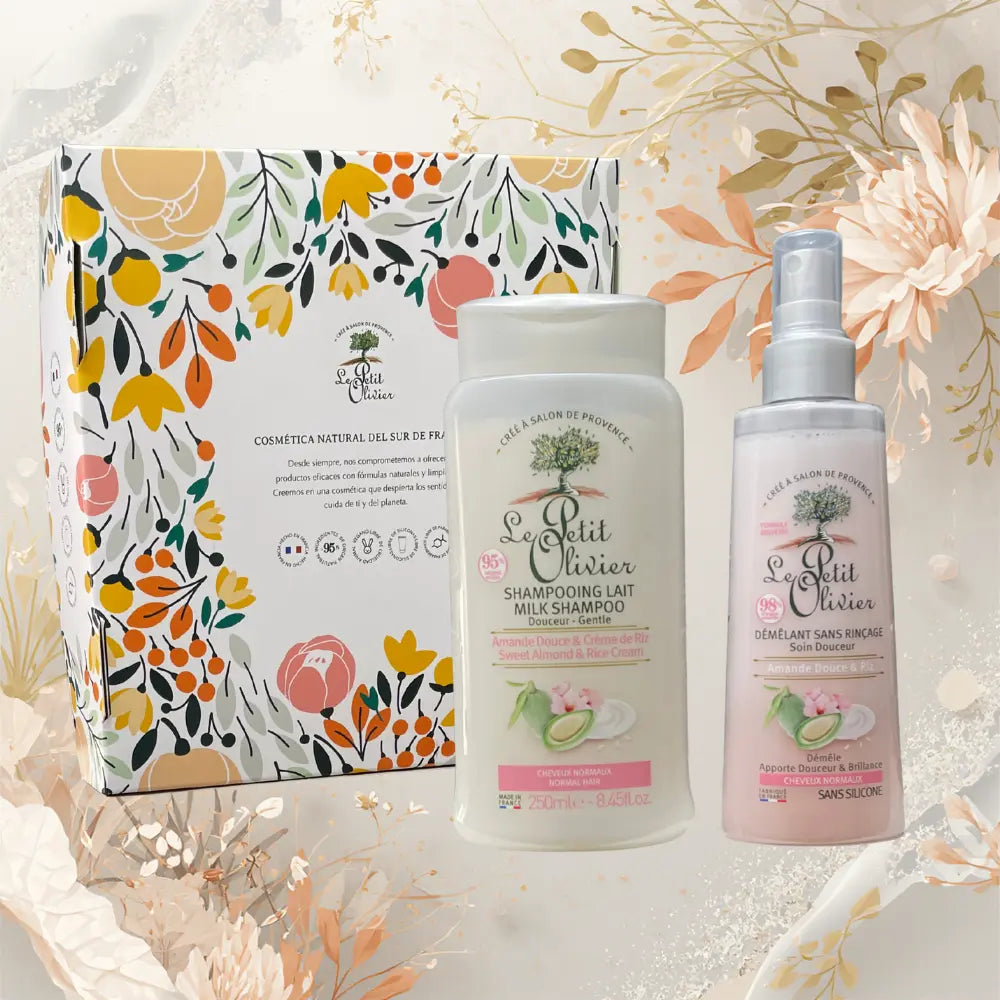Set Le Petit Olivier con shampoo y desenredante de almendra dulce y crema de arroz sobre fondo floral natural y suave