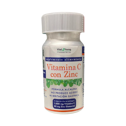 Frasco del suplemento alimentario Vital Young Vitamina C con Zinc. Contiene fórmula alcalina que no produce acidez ni irritación gástrica. Indica que 2 cápsulas diarias aportan 1.000 mg de vitamina C y 20 mg de zinc elemental. Etiqueta en blanco con detalles en azul y rojo.
